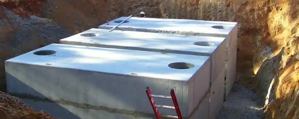Septic tank installation site with a newly placed concrete tank in Warwick, RI
